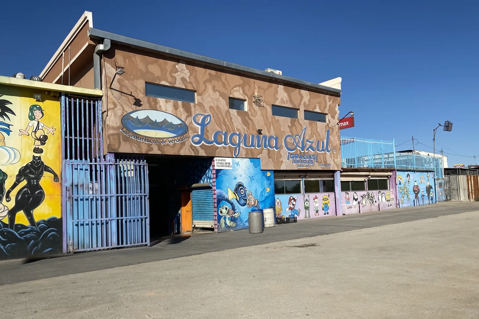 Facade of the Laguna Azul seafood restaurant on Calzada Independencia, Mexicali, with its script sign and ocean murals
